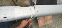 Splicing the mast - we wrapped the male insert with rope and twisted to compress it enough to squeeze into the female mast