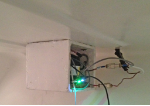 The compressor in its box, with pipework feeding up to the fridge above.