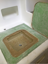 Panel with bowl wedged     in place before surface levelling. Note the useless packaging-tape ledge